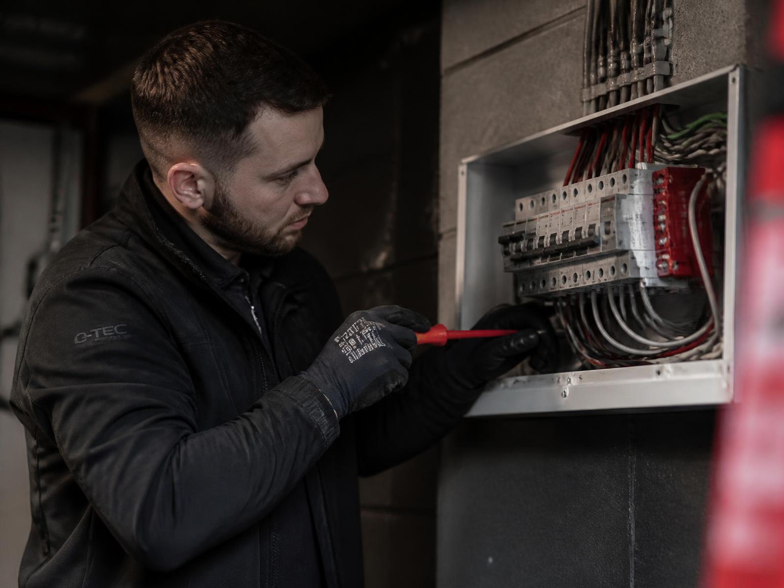 Electrician wiring a consumer unit